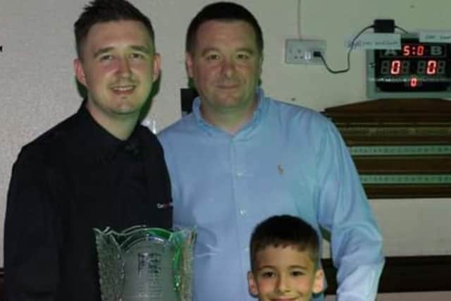 The Cue Club has hosted many snooker greats, such as (pictured) Kyren Wilson with Steve and William Roebuck and the Paul Hunter trophy that Kyren won that year