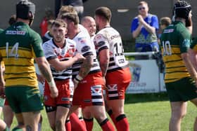 Clark Thompson congratulated on scoring a try for Normanton Knights against Woolston Rovers. Picture: Rob Hare