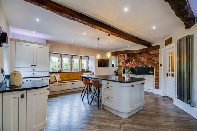 The kitchen has a good range of integrated appliances, as well as a characterful window seat, helping create the practical hub of this lovely family home.