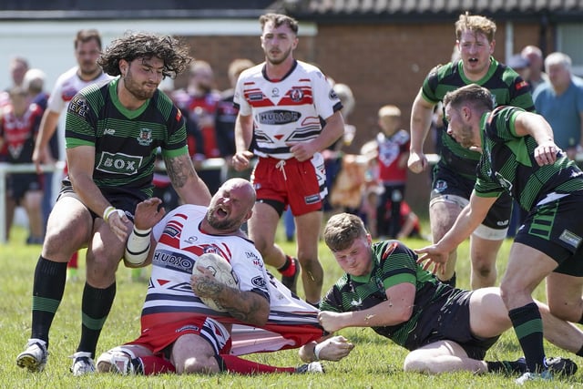 Normanton Knights' Adam Biscomb is dragged back.