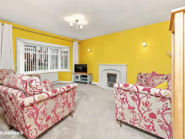 The spacious living room offers a comfortable setting for relaxing and entertaining.