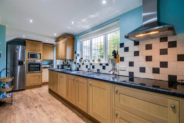 The kitchen with fitted units benefits from plenty of natural light.