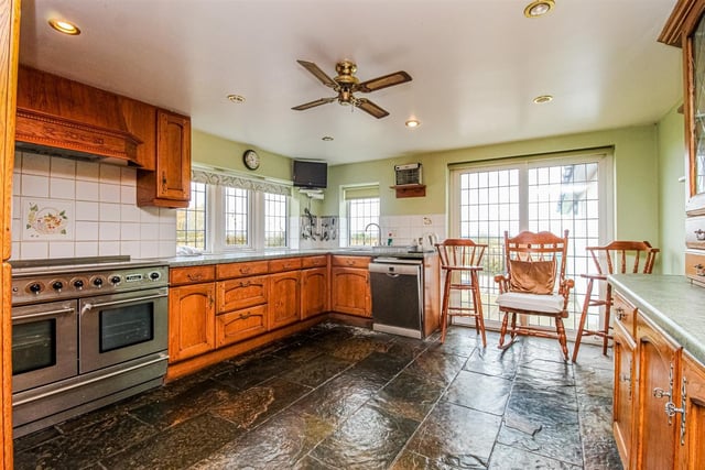 A bright and spacious kitchen has French doors leading outside to a patio area.