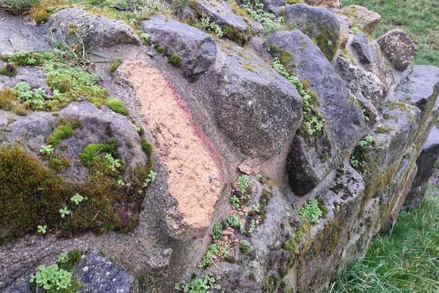Damaged sandstone at the castle. The damage can be caused by people climbing on walls or frost. Any damage is logged by site officers to inform future maintenance of the stonework