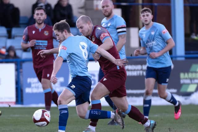 Chris Dawson looks to get away from Pontefract Collieries' Adam Priestley on his debut for Ossett United. Picture: Scott Merrylees