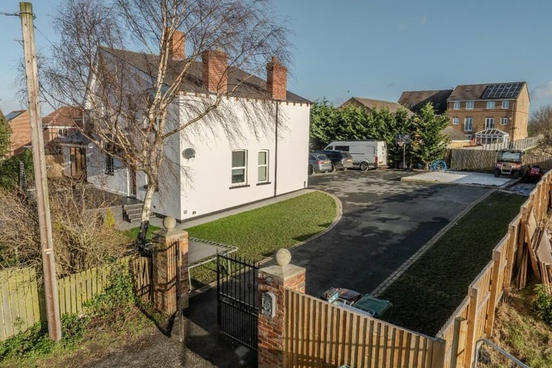 To the side of the property are large gates, a tarmacadam driveway and a double garage with an electric door and attic storag space.  with staircase.