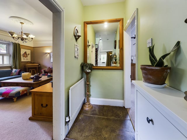 The hall through to living room within the house.