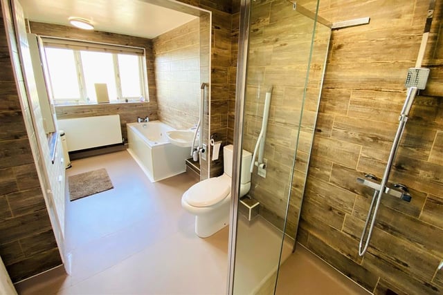 This spacious facility has a bath and a walk-in shower.