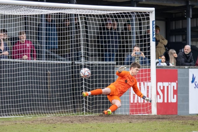 Hemsworth MW goalkeeper Ally Hughes is beaten by a fifth minute penalty taken by Emley's Alex Metcalfe.
