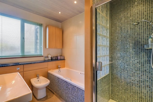 This bathroom within the bungalow has both bath and shower cubicle within its suite.