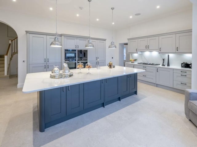 The highly imposing bespoke, fully fitted kitchen is a chef's dream with abundant cupboard space featuring pull-out larder cupboards and an enlarged quartz kitchen island.
