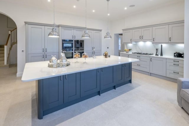 The highly imposing bespoke, fully fitted kitchen is a chef's dream with abundant cupboard space featuring pull-out larder cupboards and an enlarged quartz kitchen island.