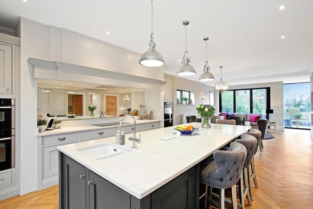 This open plan kitchen/ dining room and family room has full height double glazed windows making the most of the views over the garden and two central heating radiators.