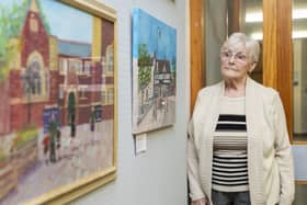 Alma Harrison with two of her paintings at Pontefract Art Club's exhibition at the town's library.