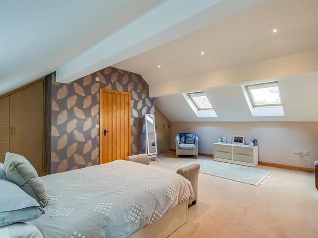 This bedroom has Velux windows bringing in plenty of natural light.