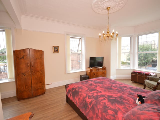 This double bedroom benefits from natural light from several large windows.