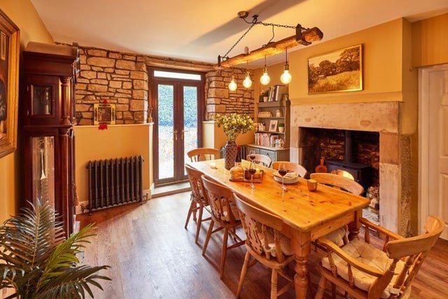 A Yorkshire stone fireplace with stove is a central feature of the dining area.