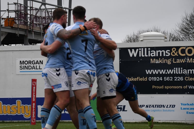 Featherstone Rovers players congratulate Riley Dean for setting up their first try at Wakefield.