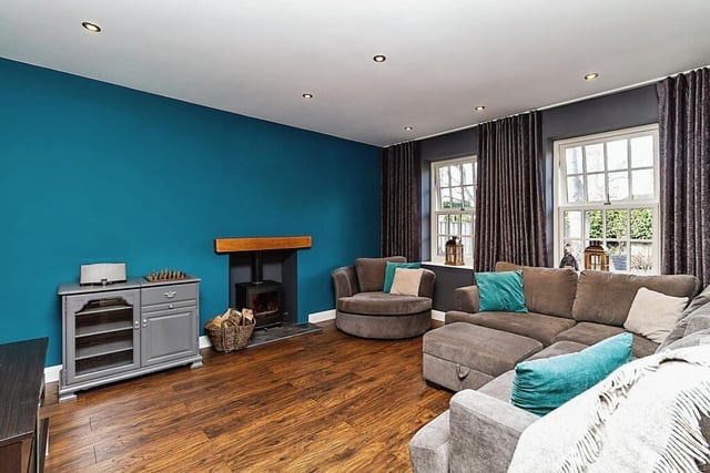 A light and spacious lounge has a cosy multi-fuel log burner.