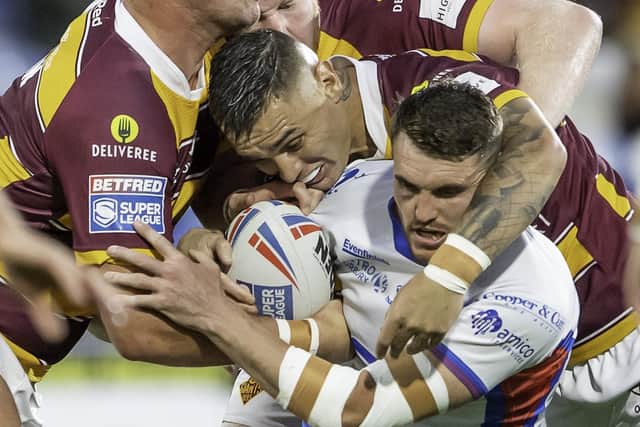 Nathan Mason in action for Huddersfield Giants against his new club, Wakefield Trinity, as he combines with Matty English to tackle Lee Gaskell. Picture: Allan McKenzie/SWpix.com