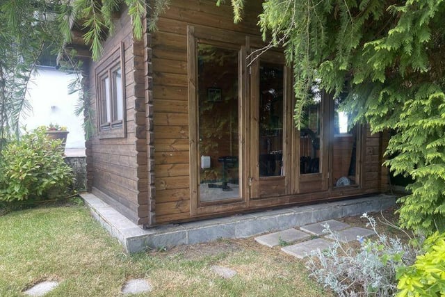 The timber summer house with power and light could potentially be adapted for use as a home office, gym or playroom.