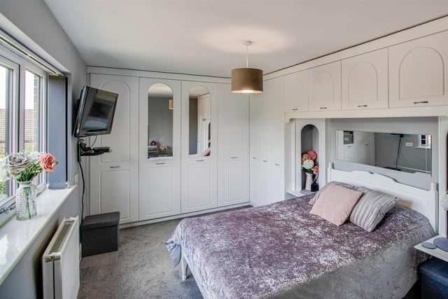 A double bedroom with fitted furniture.