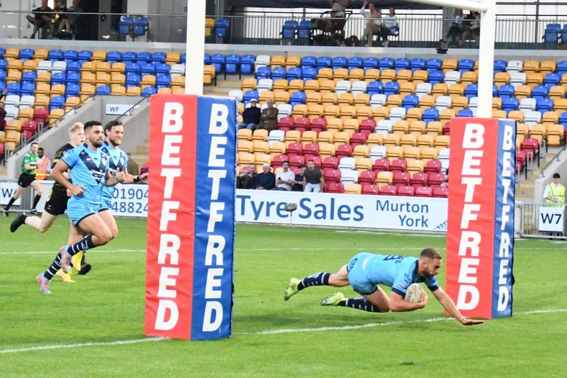 Connor Jones dives over for a try.