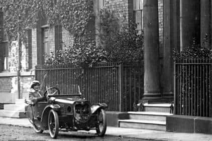A postcard showing a woman in a car outside number the property on South Parade, Wakefield, in the 1920s. Picture courtesy of Wakefield Libraries