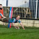 Lachlan Walmsley flies over for his hat-trick try to seal a thrilling 20-12 win for Wakefield Trinity over Featherstone Rovers. Photo by John Victor.