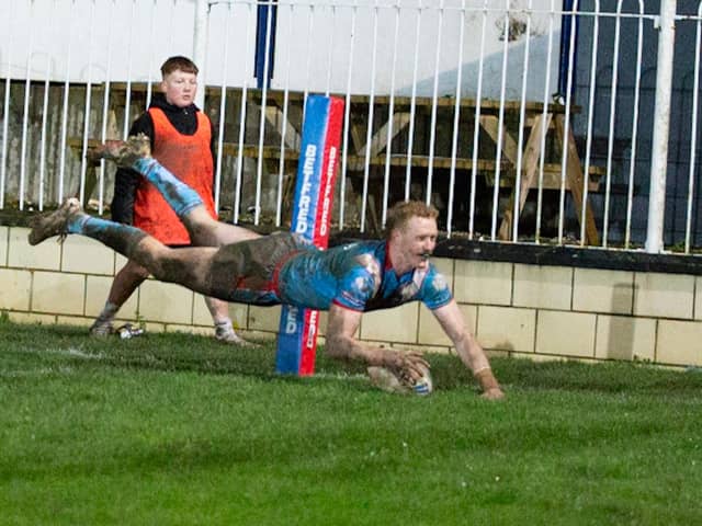 Lachlan Walmsley flies over for his hat-trick try to seal a thrilling 20-12 win for Wakefield Trinity over Featherstone Rovers. Photo by John Victor.