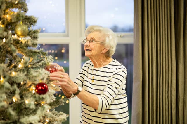 Jean, who has been sharing her past Christmas memories as part of Hepworth's "Merry Memories" campaign, pictured decorating a Christmas Tree