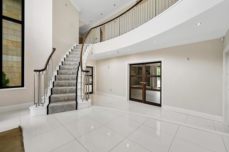 A grand and spacious hallway with staircase to the gallery landing.