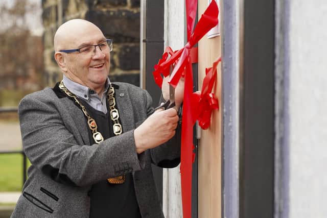 Featherstone mayor Jack Hutsby officially unveils the new premises for the Featherstone Uniform Bank.