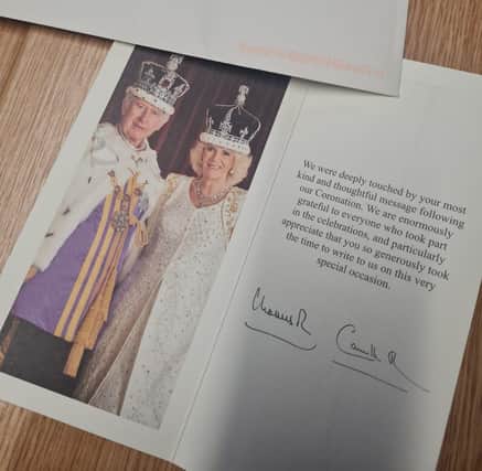 The signed card which the academy received from King Charles III and Queen Camilla.