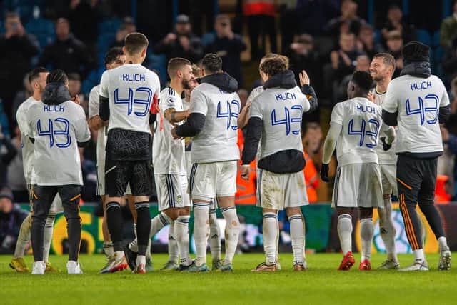 Mateusz Klich is applauded off by special T-shirt wearing Leeds United players as he leaves the Elland Road pitch for the last time.