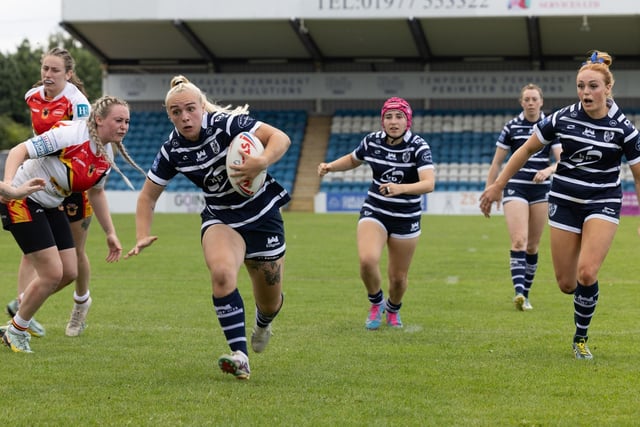 Chloe Billington charges in to score a try.