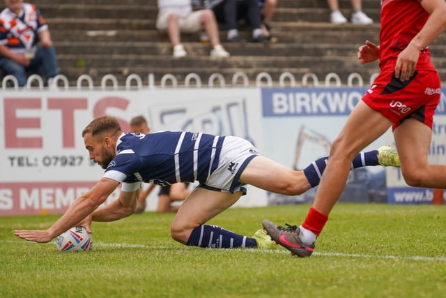 Connor Jones dives over for a try.