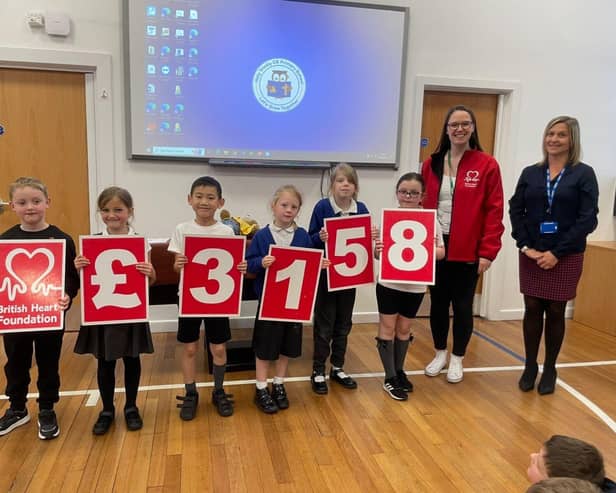 It figures: Holy Trinity Primary School children display the school's impressive fund-raising total