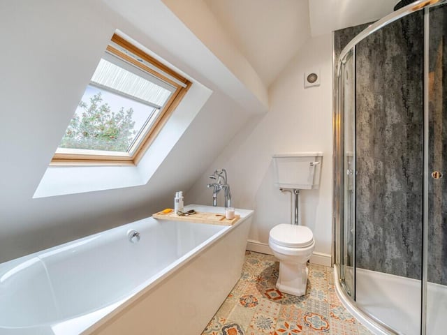 The modern bathroom with both bath and walk-in shower.