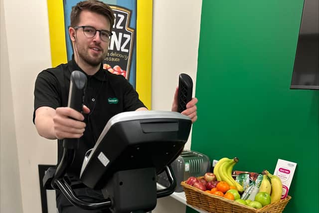 Staff member, David Ball, using the newly installed exercise bike at Normanton's Specsavers.
