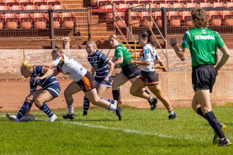 Chloe Billington goes over in the corner for a try.