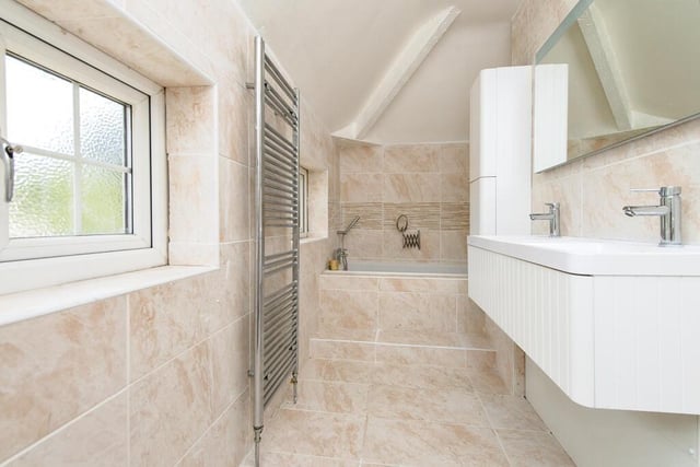 This beautiful family bathroom is fit with gorgeous marbled tiling.