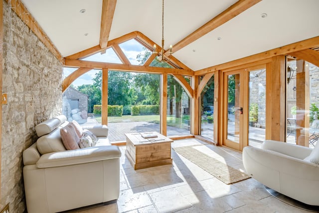 The oak-framed garden room leads out to a seating area.