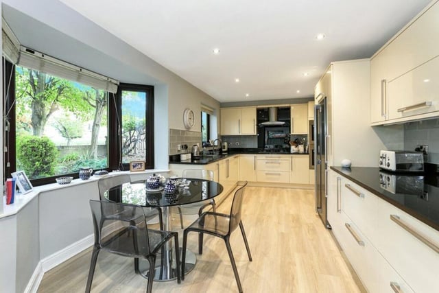 The modern kitchen with diner features granite worktops, and has a built-in double oven with additional integrated appliances.