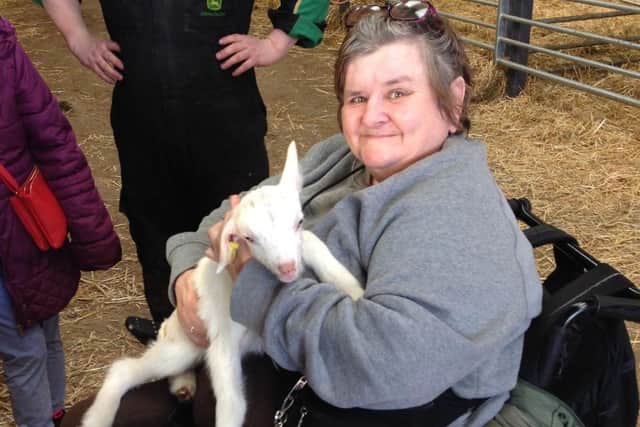 Mandy enjoying a cuddle with a goat kid at a recent Open Country farm visit.