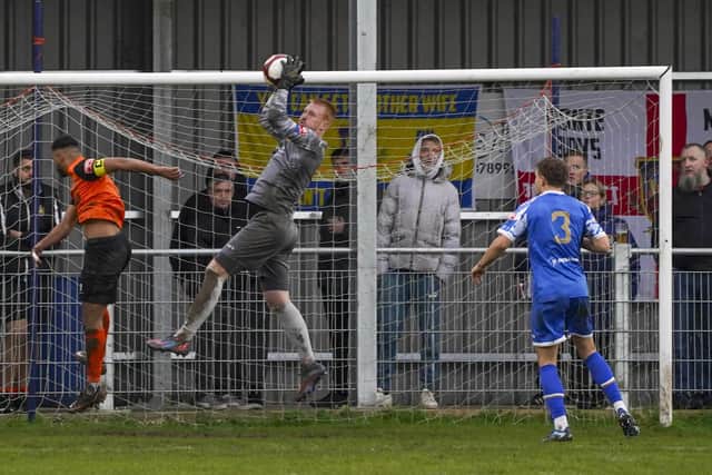 Pontefract Collieries goalkeeper Lloyd Allinson claims the ball against Brighouse Town. Photo by Scott Merrylees