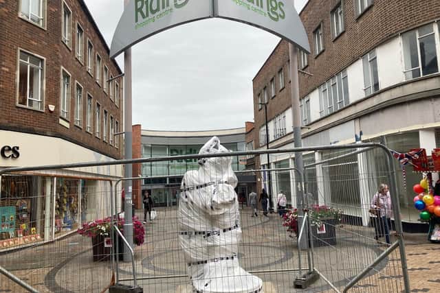 An 'Amazon love god' statue has been installed in Wakefield city centre. The sculpture will remain under wraps until it is unveiled to the public on Friday.