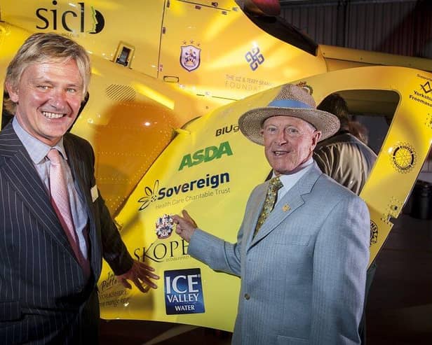Russ Piper pictured next to the Trust’s logo on the helicopter, with Geoffrey Boycott.