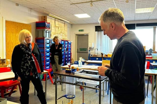 Volunteer Ian shows the new Pumping interactve he has made to staff at the museum.