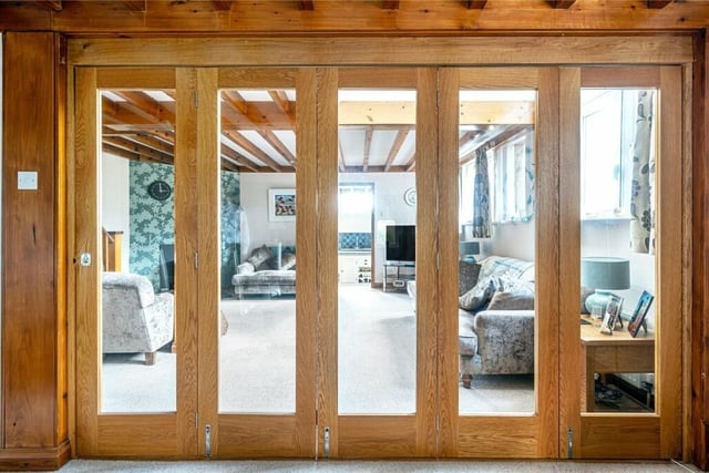 Attractive bi-fold doors separate lounge and dining areas when closed.